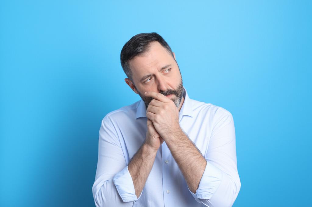 thoughtful middle aged man feeling tired and concerned about health