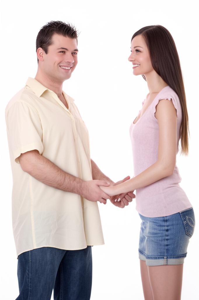happy young couple holding hands and smiling