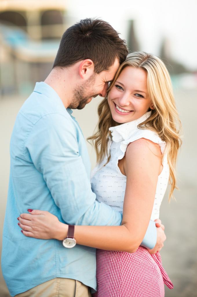 A happy couple hugging and smiling at each other.